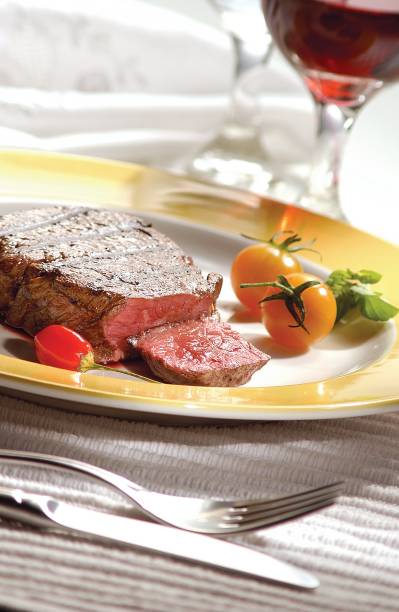 Dish of grilled meat, tomatoes and pepper
