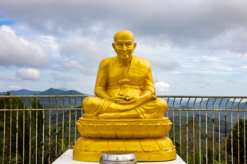 a old jesus statue at a view point of arenal volcano national park in costa rica.