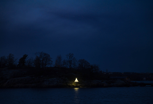 A single light as seen from a boat outside of Stockholm, Sweden