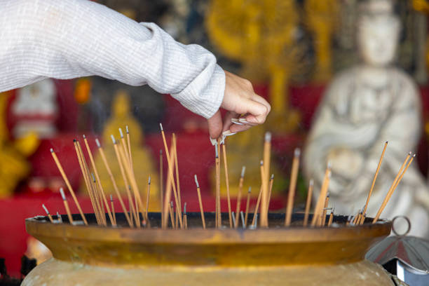 Old historical metal Censer at budhist temple, praying in temple, people lights incense and praying.