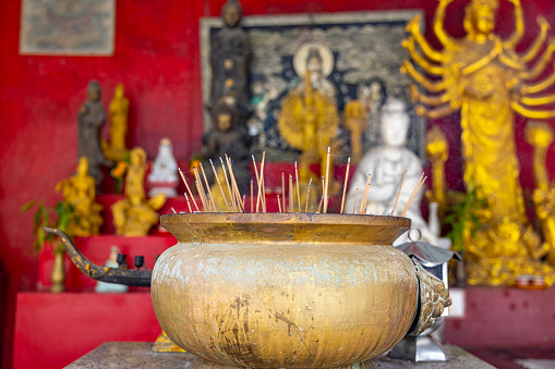 Old historical metal Censer at budhist temple, praying in temple, people lights incense and praying.