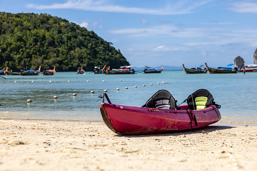 Phuket , Thailand - March 22, 2016: View Of Lots Of Tourists Some Are Sitting Down,Sunbathing,Walking Around,Parasailing,Including Vehicle Towing Removing Lots Of Jet Skis From The Beach With The Owners Sitting On It At Patong Beach Phuket Thailand Southeast Asia