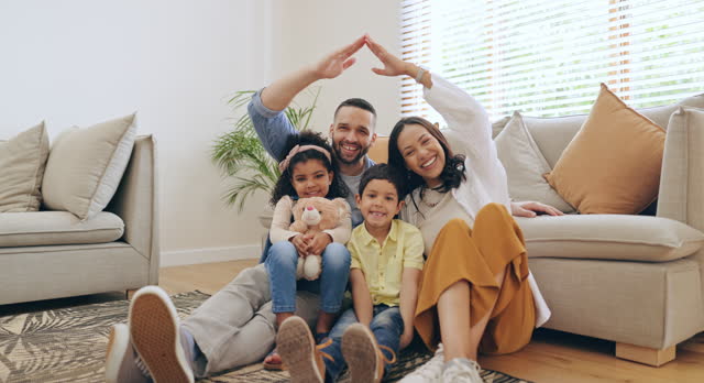 Family, roof or hands together for portrait of kids on floor in living room at home for support or insurance. Security, protection or happy parents with children siblings for love, safety or care