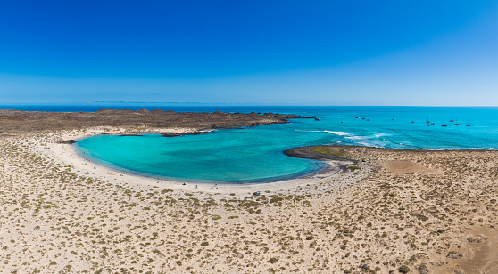 Aerial panoramic landscape view of the beautiful secluded tropical looking natural bay and the island Isla de Lobos near Corralejo, Fuerteventura,  Canary Islands, Spain