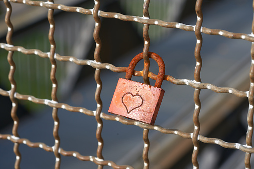 Lock with a heart on the fence.