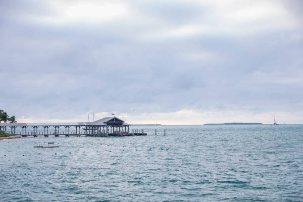 istock Fishing pier over the ocean and storm clouds 1990926908