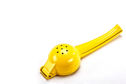 Manual yellow lemon squeezer isolated on white background