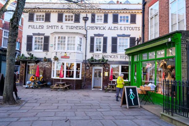 London, UK - 16.01.2024. The Prince's Head pub from The Green, Richmond upon Thames, West London. Selective focus. Horizontal. England. Red telephone box. winter in London.