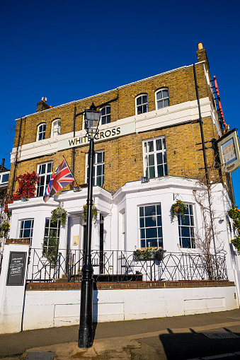 London, UK - 16.01.2024. The White Cross pub in Richmond upon Thames in London. Beautiful old building of The White Cross, a piece of local history and home to the famous Richmond riverside. Serving Young’s fine ales since 1869 and built in 1780