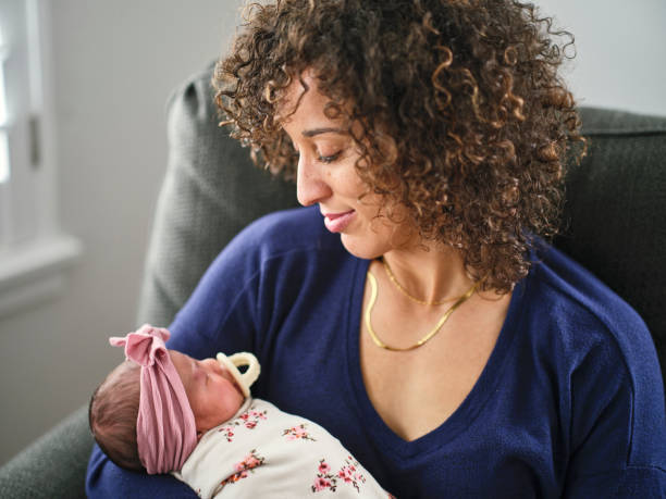 istock Young Mother Holding a Newborn Baby 1990971447