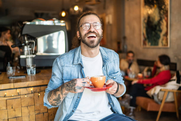 istock Cheerful man drinking coffee in a cafe 1991004082