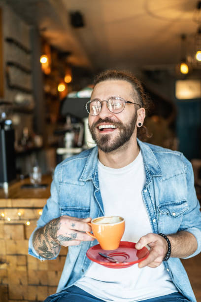 istock Cheerful man drinking coffee in a cafe 1991006250
