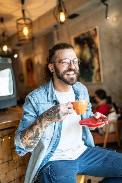 istock Cheerful man drinking coffee in a cafe 1991007709