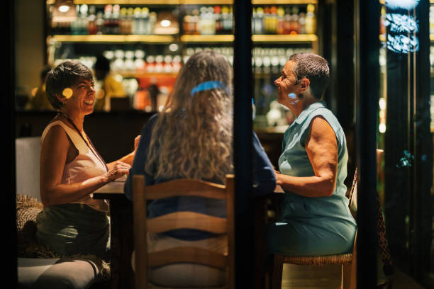 istock Laughing mature women having dinner together inside a restaurant 1991022601