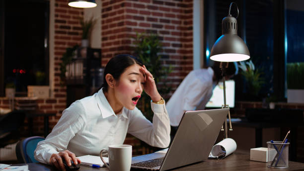 istock Office employee sighing in frustration, feeling overworked 1991024736