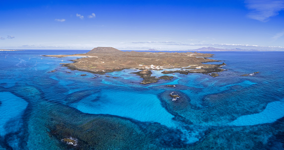 Aerial panoramic landscape view of the beautiful secluded tropical looking natural bay and the island Isla de Lobos near Corralejo, Fuerteventura,  Canary Islands, Spain