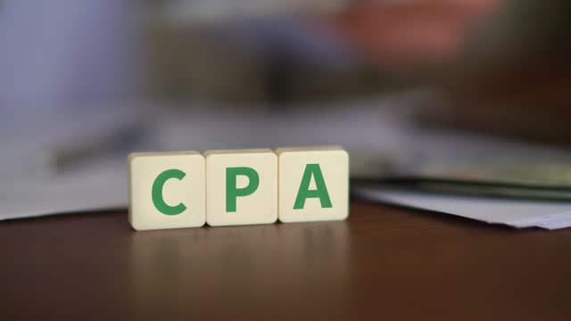 Concept of Cost Per Action advertising. CPA initials with selective focus and money on the background