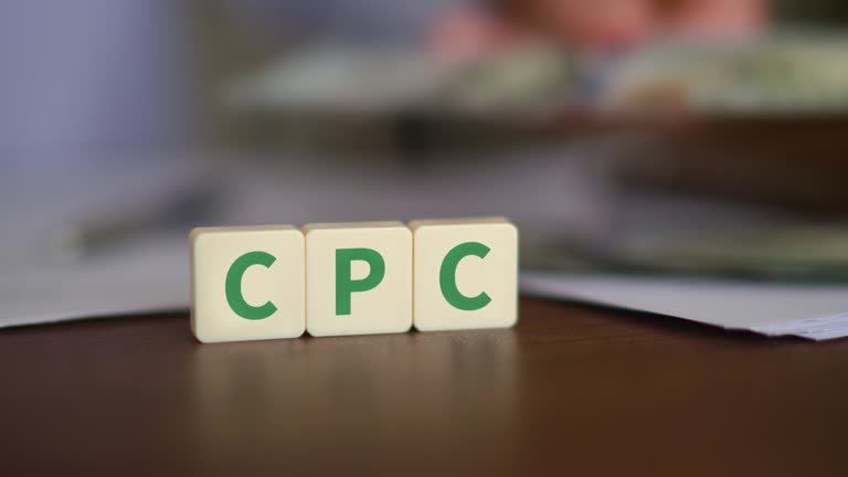 Concept of Cost Per Click advertising. CPC initials with selective focus and money on the background