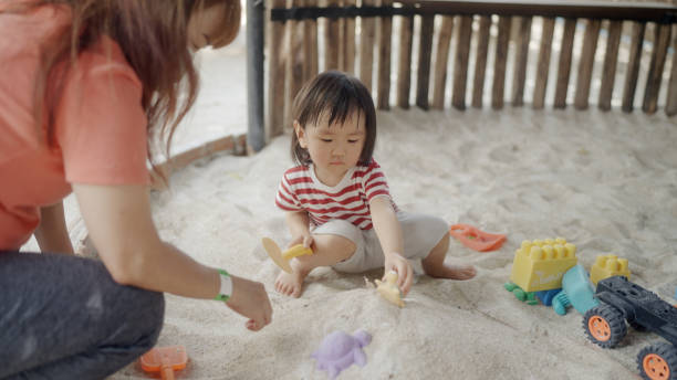 istock girl playing in the sand 1991058752