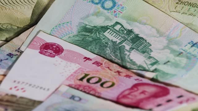 Chinese currency and banknotes of Yuan rotating upside down video from a unique cinematic perspective