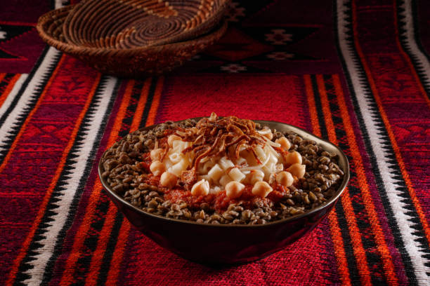 Egyptian Koshary images, Traditional Egyptian food, Delicious Koshary or Kushari Egyptian cuisine of Koshary, a popular street food made of rice, macaroni, spaghetti and lentils mixed together topped with a spiced tomato sauce, garlic vinegar, fried onions and hummus chickpeas koshary stock pictures, royalty-free photos & images