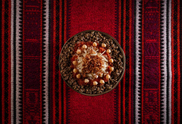 Egyptian Koshary images, Traditional Egyptian food, Delicious Koshary or Kushari Egyptian cuisine of Koshary, a popular street food made of rice, macaroni, spaghetti and lentils mixed together topped with a spiced tomato sauce, garlic vinegar, fried onions and hummus chickpeas koshary stock pictures, royalty-free photos & images