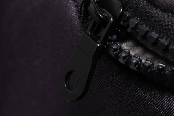 istock Close-Up View of a Black Zipper on a Textured Fabric Surface 1991083919