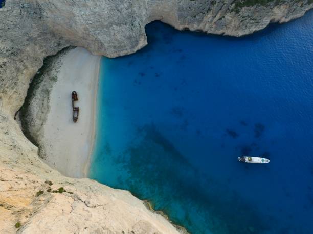 istock Anchored boat and shipwreck 1991087070
