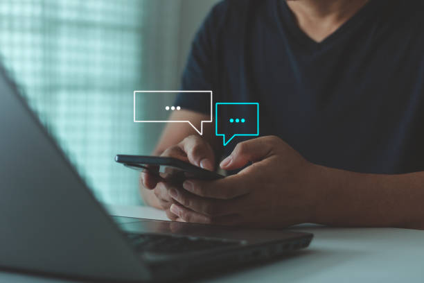 istock Text Messages, Social media marketing technology concept. People using smartphones typing in response to communication and chat working at home in chat box icons pop up for online customer service. 1991089674