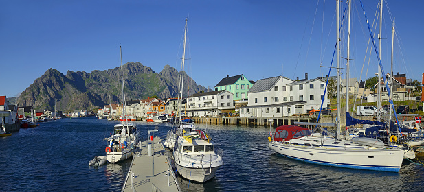 Harbor od fishing village Henningsvaer in Lofoten islands in Norway -  The Lofoten islands is on the UNESCO World Heritage Site tentative list - yachts and ships moored in the harbor