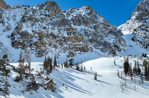 istock Skiers hiking up to a mountain ridge 1991101193