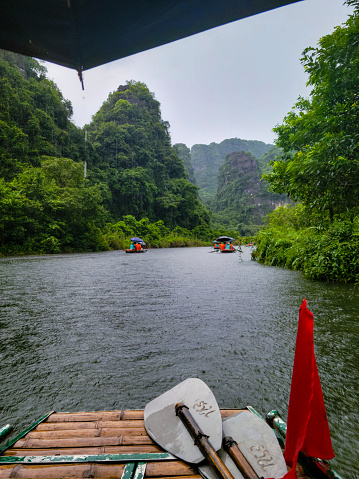 Sailing down the river in the rain, through limestone mountains.