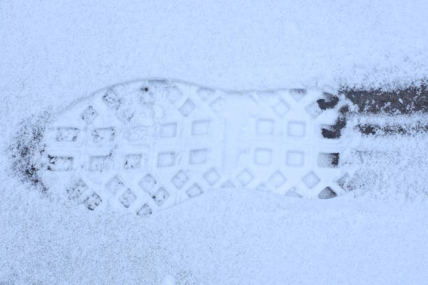 istock one trace with a pattern from the sole of a shoe on white snow 1991151003