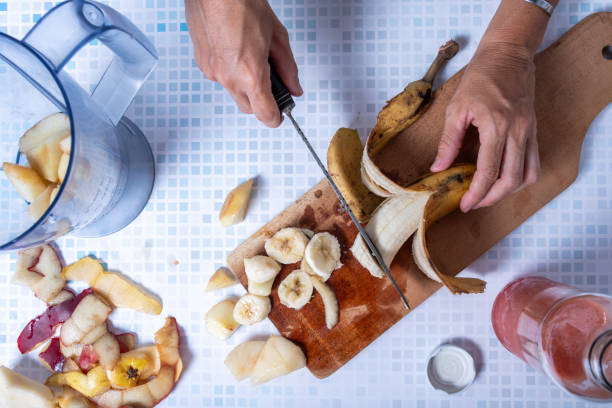 Cut fruits to make a healthy homemade smoothie.