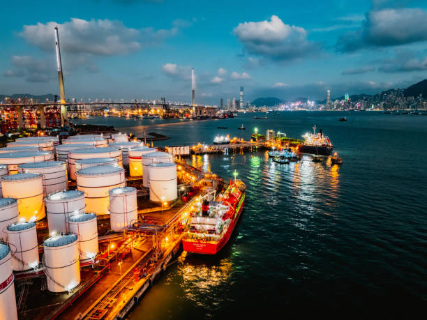 istock Tank ship loading unloading oil and gasoline at Commercial dock in sea 1991182859