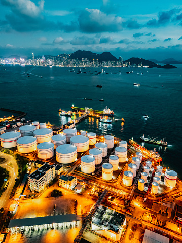 Tank ship loading unloading oil and gasoline at Commercial dock in sea