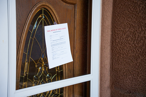 Foreclosure Notice Taped to a Front Door of a Home in a Middle Class Neighborhood