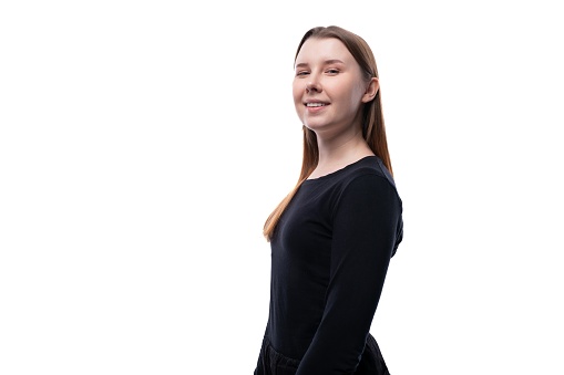 Portrait of a cute Caucasian pre-teen girl wearing a black turtleneck on a white background.