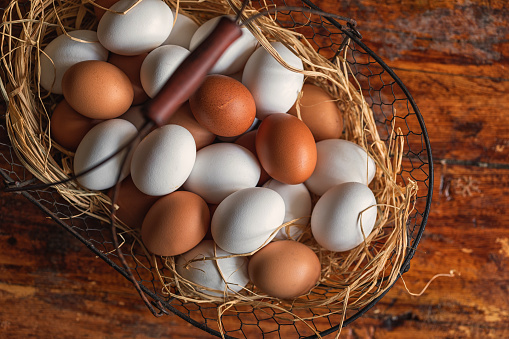 Fresh organic chicken eggs on a wooden rustic background