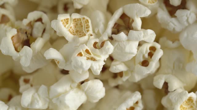 Fresh popcorn closeup rotating. Pop corn background. Macro footage of sweet popcorn