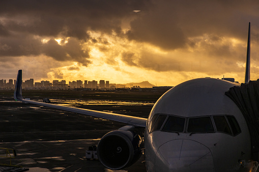 Airport and aviation scene with city in background at sunrise. Shot in Hawaii.