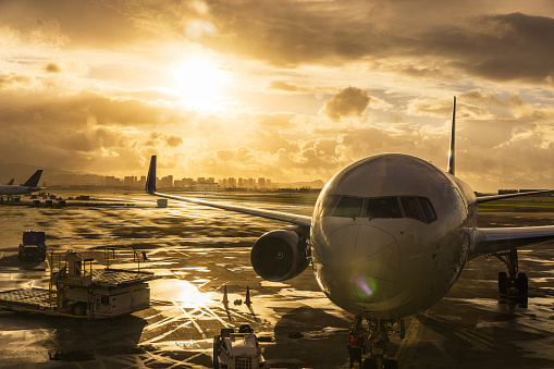 Airport and aviation scene with city in background at sunrise. Shot in Hawaii.