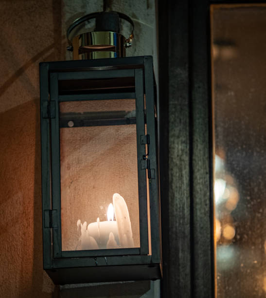 istock Burning candles against window at night 1991364426