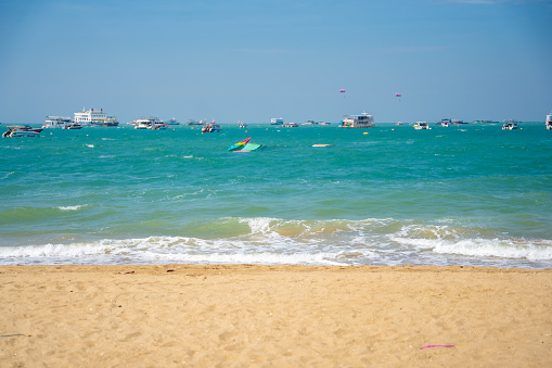 Pattaya, Thailand - December 26, 2023. Boats on turquoise water. North Pattaya beach in Thailand seaside. Pattaya, Thailand. . High quality photo