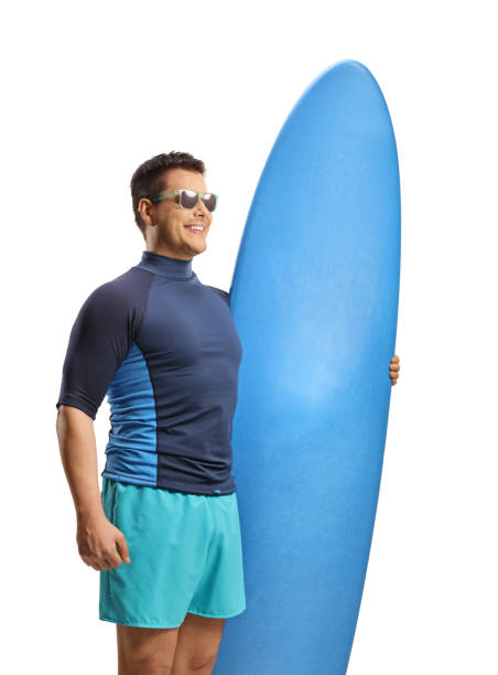 istock Man with sunglasses holding a surfing board and smiling 1991404427