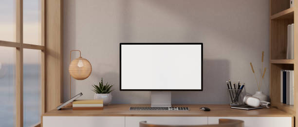 istock Minimalist Scandinavian home office with a white-screen computer mockup on a wooden table. 1991448800