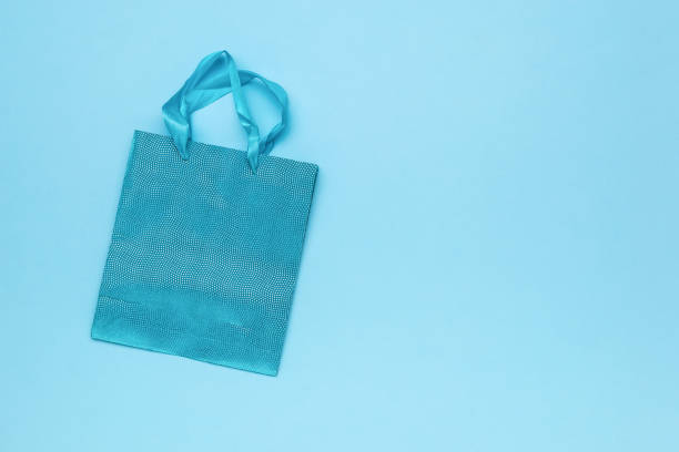 istock A shiny blue gift bag on a blue background. 1991448936