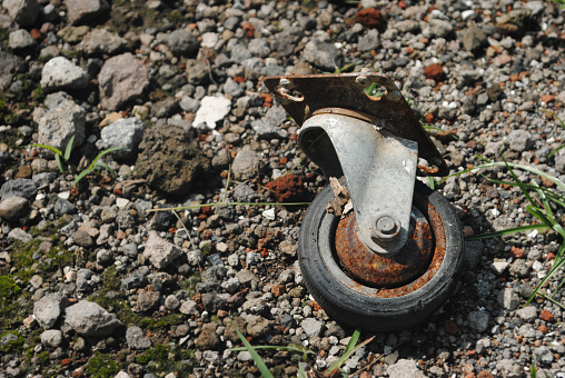 Image of abandoned rusty cart wheel.