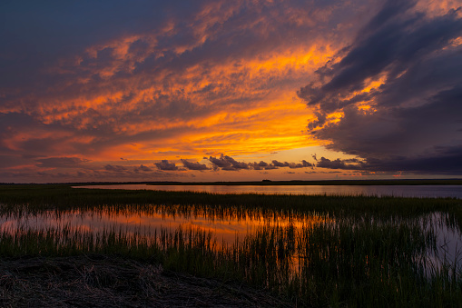 Sunset after a passing storm on an inlet in the low country of South Carolina.