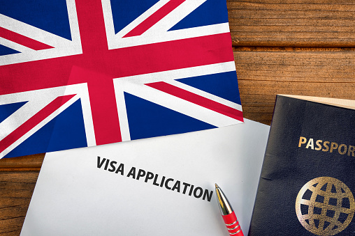 Visa application form, passport and flag of United Kingdom